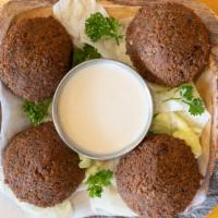 Falafels · Four pieces of falafels served with tahini sauce.