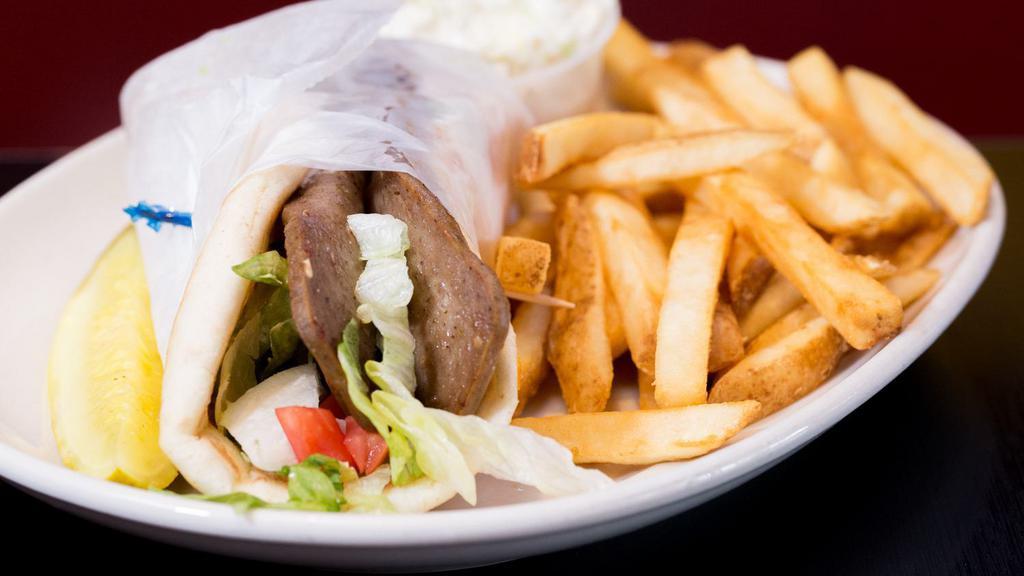 Greek Gyro · your choice of grilled lamb & beef or chicken, wrapped in grilled pita, lettuce, tomato, tzatziki sauce.