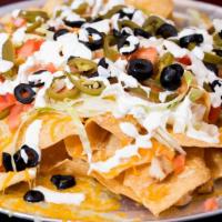 Loaded Chicken Nachos · grilled chicken, lettuce, tomatoes, shredded jack & cheddar cheese, sour cream, guacamole, s...