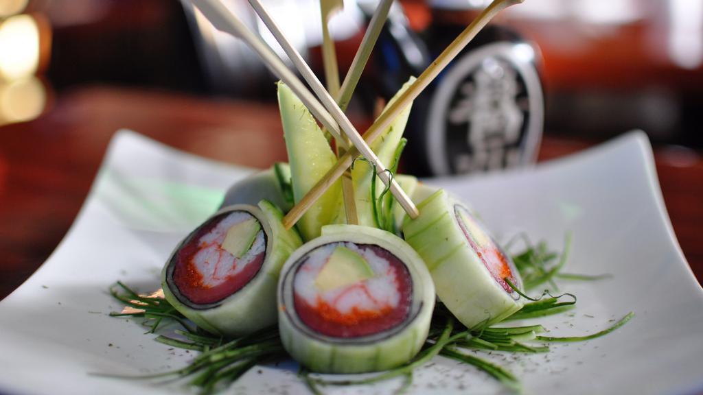 Ken Shin Roll · Kanikama, masago, tuna, and avocado wrapped with seaweed and cucumber outside.