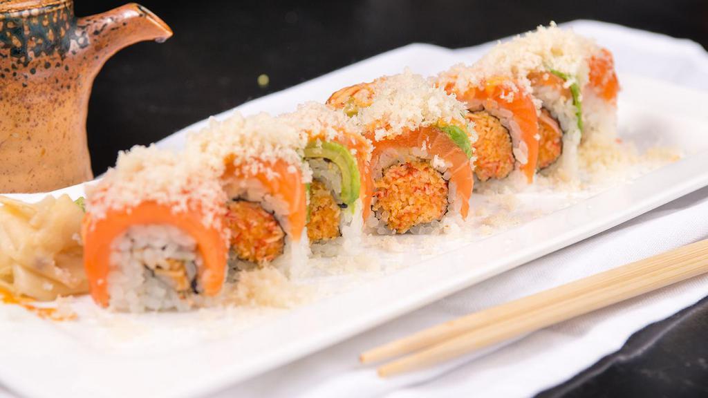 Sunshine · Spicy. Spicy kani mixed with crunch inside topped with salmon, avocado, and crunch on top.