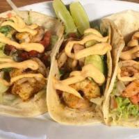 Cajun Shrimp Tacos · Topped with shredded lettuce, pico de gallo, fresh avocado, and chipotle mayo on a flour tor...