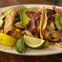Miguel'S Veggie Tacos · Black beans, sauteed red onion, topped with shredded lettuce, pico de gallo, avocado, Cajun ...
