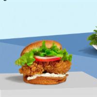 The Classic Cluck Chicken Sandwich · Halal crispy fried chicken, fresh avocados, and mayo. Served on a griddled sesame seed bun.