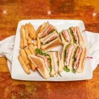 Turkey Club Sandwich · Freshly made with cheese, bacon, lettuce, tomato, and mayonnaise, layered between toasted br...