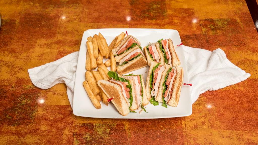 Turkey Club Sandwich · Freshly made with cheese, bacon, lettuce, tomato, and mayonnaise, layered between toasted bread.