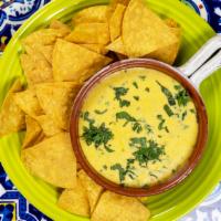 Poblano Spinach Queso Dip · Poblano peppers and spinach in a cheesy cream sauce made for dipping. Comes with chips.