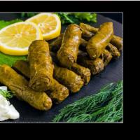 Stuffed Grape Leaves (Dolma) · Fresh grape leaves stuffed with rice, pine nuts, and fresh herbs served with yogurt dip and ...