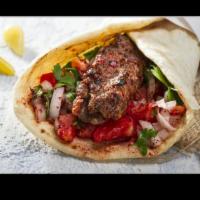 Adana Wrap/Pita · Grilled ground lamb skewer, tomatoes, lettuce, onions, hummus with yogurt dip/hot sauce in p...