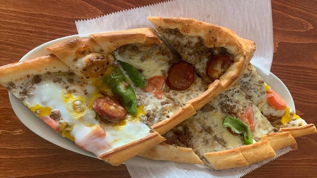 Combo Pide · Stuffed dough dish of mozzarella cheese, ground beef, beef sausage, peppers and egg topping.