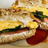 Shepherd Sandwich · Scrambled eggs, goat cheese, tomato, greens, on an everything Philly muffin served with brea...