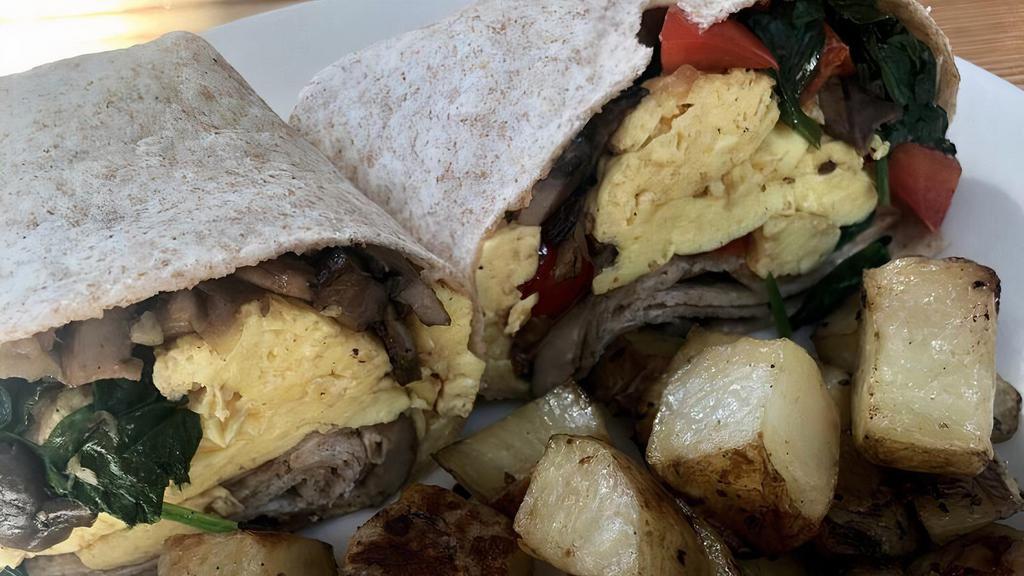 Garden Wrap · Scrambled eggs, sautéed spinach, red pepper and onions, and whole wheat wrap served with breakfast potatoes.