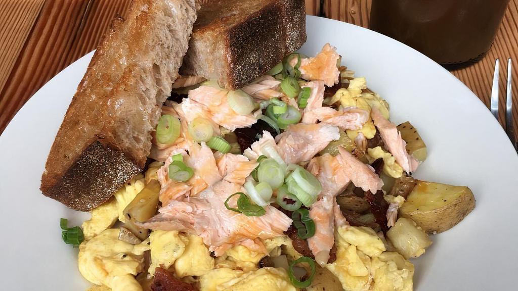 River Hash · Scrambled eggs, potatoes, bacon, poached salmon, hot honey, and thick wheat toast.