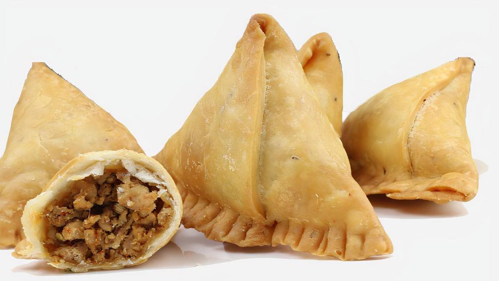 Chicken Samosa 2Pcs · (Our Home Made)South Asian fried  pastry with a savory filling like spiced potatoes, onions, peas, chicken and other Spices. Comes with Ciliantro mint Yogurt and ,Sweet & Spicy tamarind Sauce.