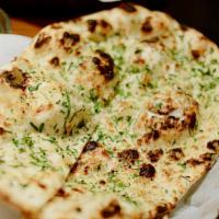 Garlic Naan · Minced Garlic Cilantro rubed on the dow before cooked in Clay Oven.
