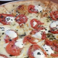Capri Sicilian Pizza · 8 Slices. Fresh mozzarella, tomatoes, basil in a garlic oil sauce.