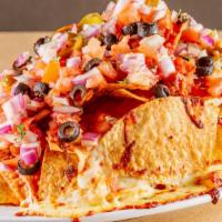 Cheese Nachos · Nachos topped with piping hot cheese, chopped tomatoes, jalapeño peppers, onions, olives, sa...