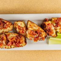 Potato Skins · Stuffed with mozzarella cheese and bacon, served with sour cream and crisp celery.