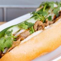 Grilled Pork Banh Mi · Toasted and spread with in-house Vietnamese mayo. Contains pickled carrots and daikon, cucum...
