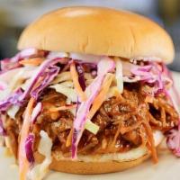 Pulled Bbq Sandwich · In-house Smoked Pulled Pork tossed in BBQ sauce, topped with Cole slaw on a brioche bun