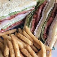 Turkey Club · White or wheat bread served with lettuce, tomato, bacon, mayo choice of two sides fries, oni...