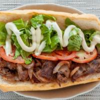 Steak & Cheese Subs · 100% rib-eye steak & melted cheese, grilled onions, lettuce, tomatoes, mayo, pickles, and ho...