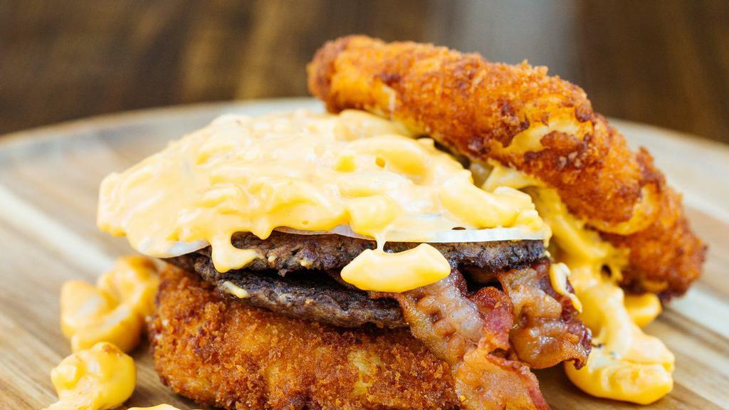 Special Mac N Cheese Heaven · Two thin burger patties placed between two fried mac n cheese buns, and then topped with bacon, onions, and then stuffed with more mac n cheese.