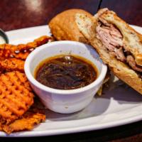 French Dip Sandwich · Tender sliced prime rib, caramelized onions, swiss cheese, drizzled with horseradish sauce o...