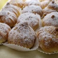 Cream Puffs · Pastry shell filled with vanilla custard topped with powdered sugar.