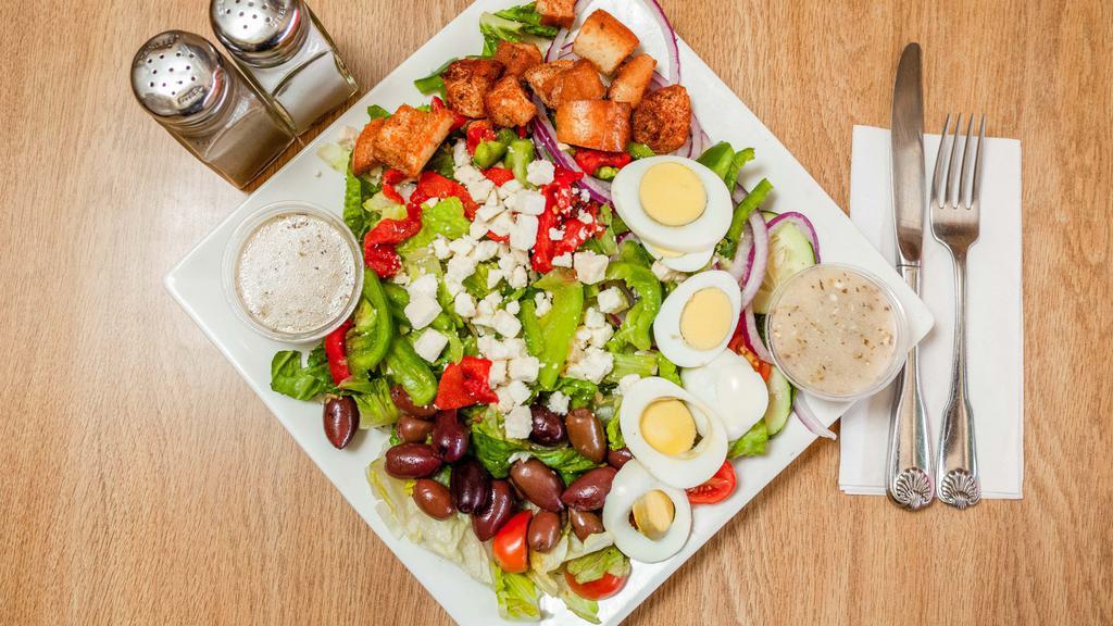 Greek Salad · Lettuce, tomatoes, green peppers, cucumbers, hard boiled egg, black olives, red onions and feta cheese.