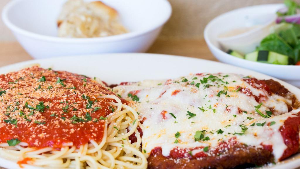 Chicken Parmigiana · Lightly breaded cutlet topped with sauce and mozzarella cheese. Served with soup or salad, side of pasta and garlic knots.