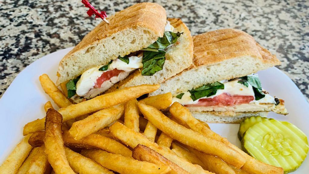 Chicken Caprese Panini · Grilled chicken, fresh mozzarella, tomato and basil. Served on ciabatta bread with french fries and pickles.