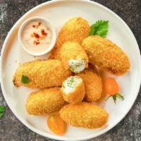 Holy Jalapeno Poppers · Fresh jalapenos coated in cream cheese and fried until golden brown.