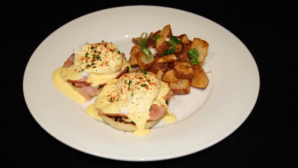 Eggs Benedict · Two poached eggs, toasted English muffin with shaved ham and hollandaise sauce. Served with breakfast potatoes.