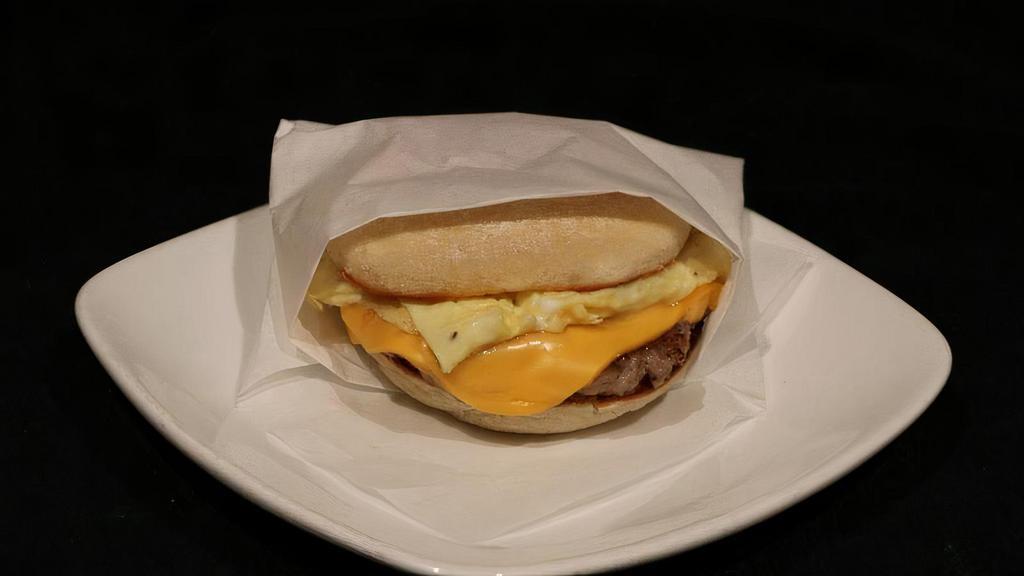Breakfast Butty · Scrambled egg topped with a banger patty and american cheese.  Served on an english muffin.