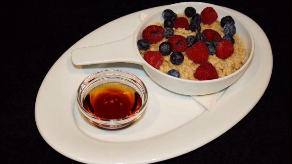 Steel Cut Oatmeal · Steel cut oatmeal with fresh fruit on top and maple syrup on the side.
