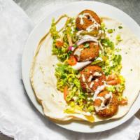 Falafel Sandwich · Vegan-option. Served on pita bread or with rice with a variety of side.