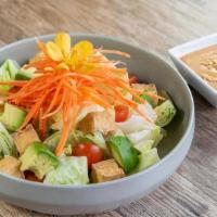 Thai Salad · With lettuce, Avocado, Carrot, Tomato and tofu served with peanut sauce.