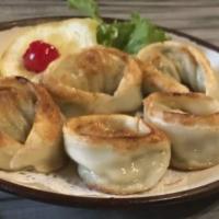 Vegetable Gyoza · Pan fried Vegetable dumplings, served with a soy dipping sauce.