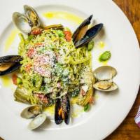 Zuppa Di Pesce Del Giorno · Fresh assortments of seafood, sautéed and served over a bed of linguine or risotto in a garl...