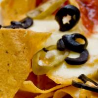 Nachos · Tortilla chips with queso, black beans, cheese, pico de gallo, onion, cilantro, jalapeno and...