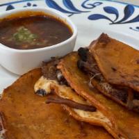 Quesabirria · 3 Birria-soaked corn tortillas, Oaxaca cheese, pulled short rib, consommé dipper.