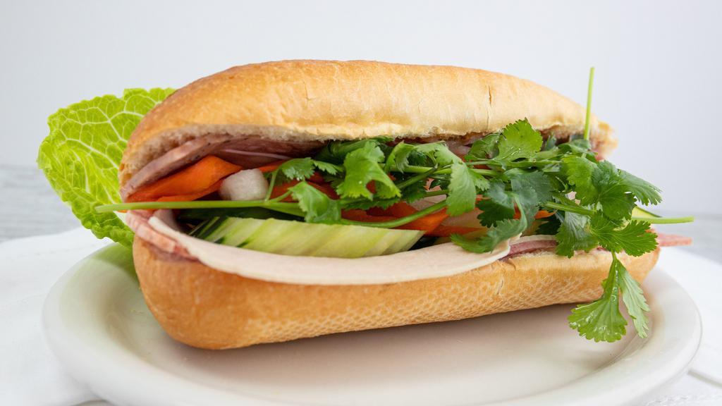 Vietnamese Sandwich · Pate, pickled vegetables, pepper, cucumber, cilantro with pork or chicken or tofu stuffed in a warn, toasted hoagie.