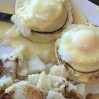 Eggs Benedict · Tow poached eggs over a toasted English muffin with Canadian bacon, topped with hollandaise ...