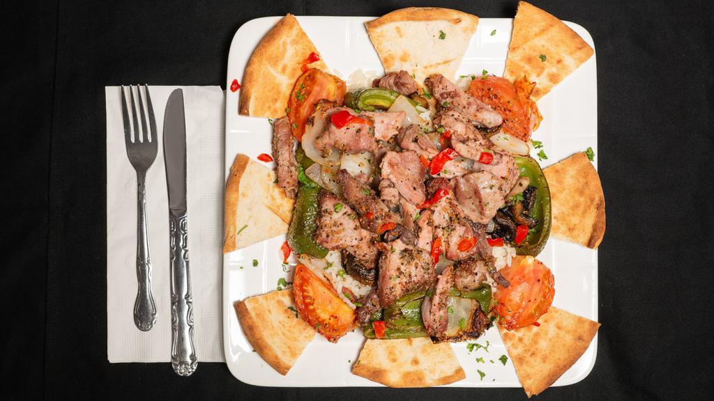 Kabob · Cubes of beef or pork or chicken marinated with herbs and skewered with tomatoes, peppers and onions, served with rice, pita bread and soup or salad.