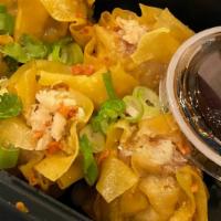Kanom Jeeb · Crabmeat, minced pork and water chestnuts wrapped in wonton skin, steamed and served with Th...