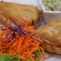 Curry Puff · Puff pastry filled with minced onion, potato, and chicken in mild curry.