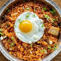 Kimchi Fried Rice · Korean style fried rice with kimchi and onions, topped with sunny side egg and your choice o...
