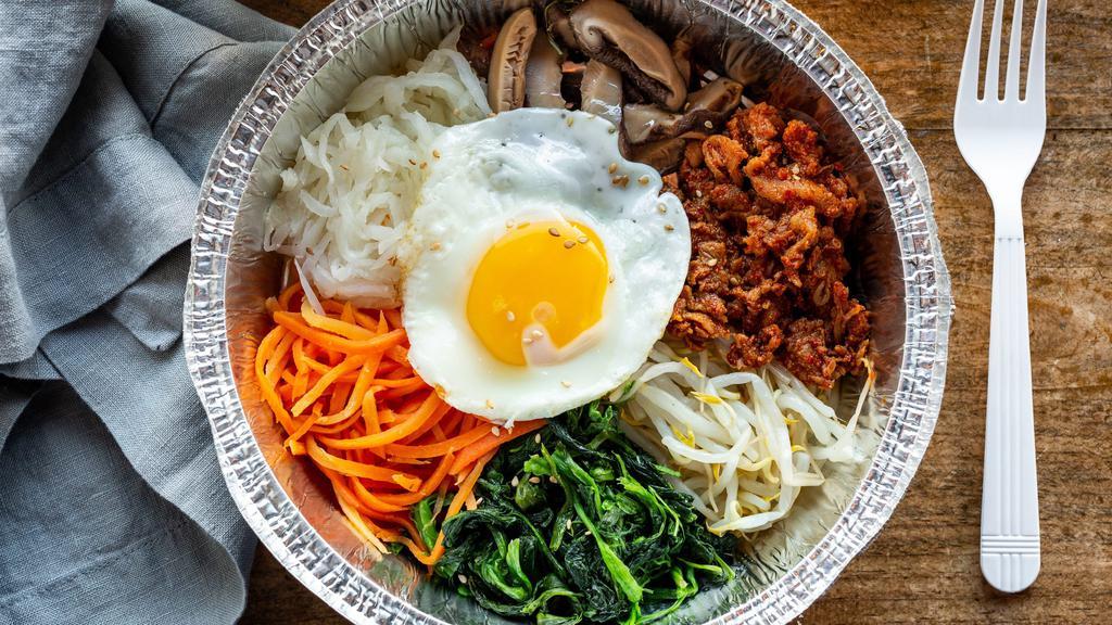 Bibimbap · Five assorted cold vegetables on a bed of rice with your choice of protein, topped with a sunny side egg.