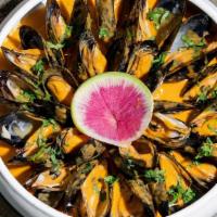 Mussels Mejillones En Curry · Mussels curried in spicy cilantro coconut milk, served with corn bread